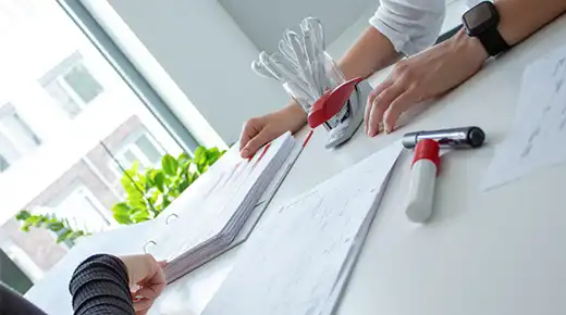 Documents are spread out on an office desk waiting to be analyzed