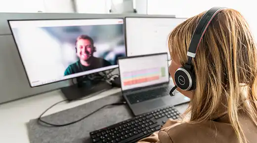 Two co-workers participating in a video call