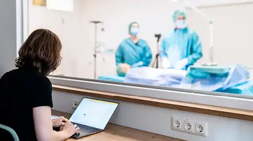 A woman documents a usability study in a lab setting