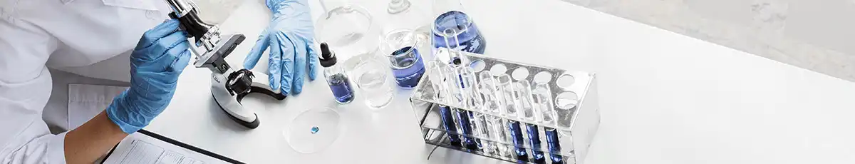 A lab setting with samples and a microscope