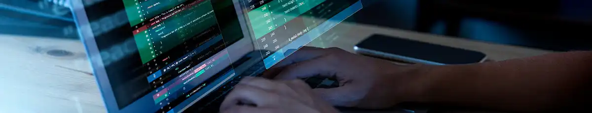 Two hands programming on a laptop