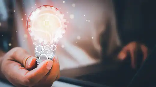 man holding AI light bulb