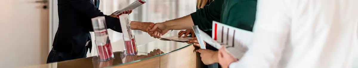 Handshake and flyer presentation at reception