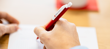 Close-up of a pair of hands taking notes