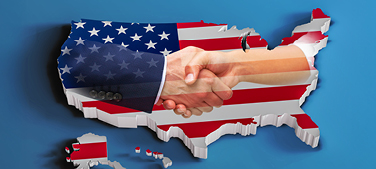 Map of the USA with a flag and people shaking hands