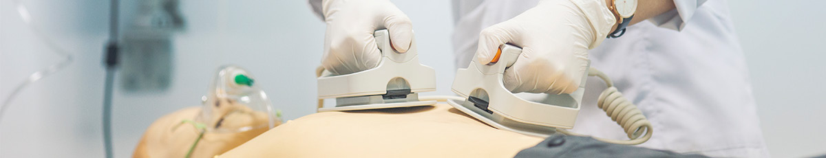 a defibrillator used on a dummy