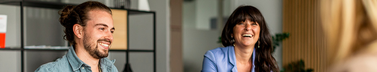 Laughing team members in an office setting