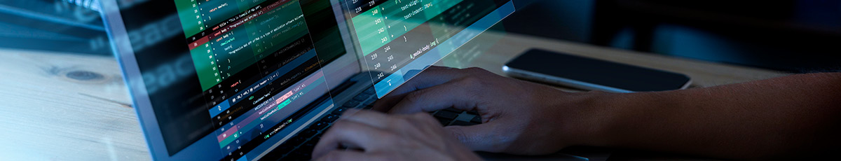 Hands typing on a laptop