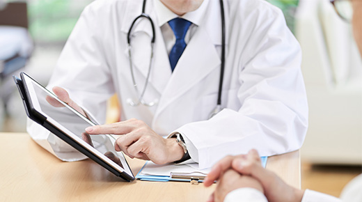 a physician explains a chart to another person