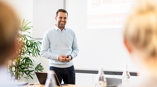 Usability expert standing in front of a presentation.