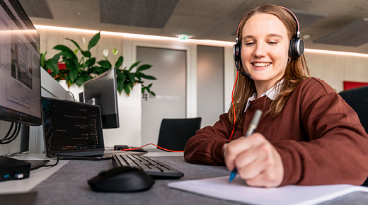 Woman with headset takes notes
